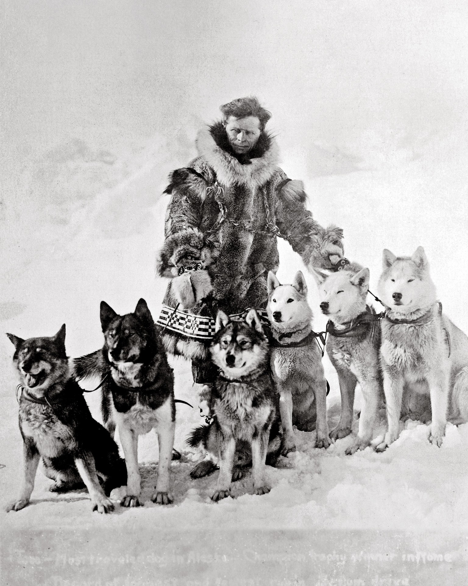 Leonhard Seppala standing with sled dogs.